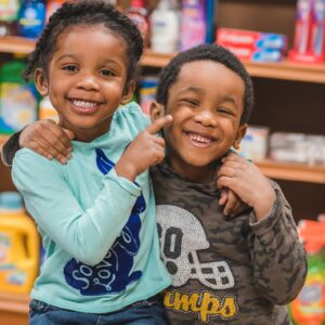 African American kids siblings playing around together making silly faces