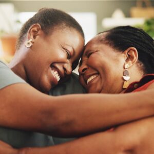 Black family, touch forehead and women with hug for love, support and care on sofa. Elderly mother,